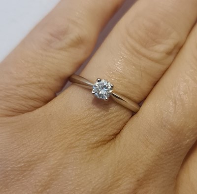 Lot 260 - A platinum diamond solitaire ring, in a four...