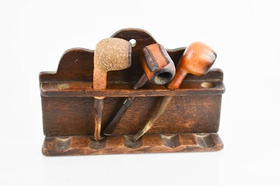 Lot 386 - A vintage treen pipe stand, with a shaped back,...