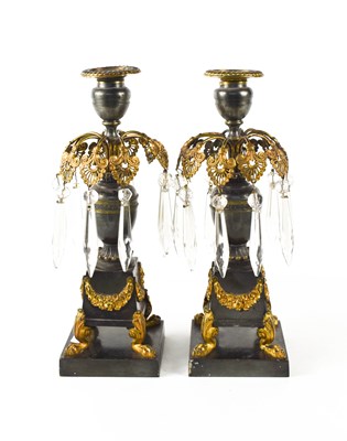 Lot 115 - A pair of Empire gilt bronze candlesticks, the...