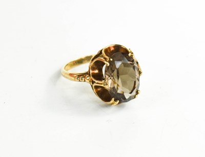 Lot 61 - A 9ct gold and smokey quartz dress ring with...