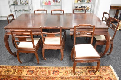 Lot 538 - A Chinese hardwood extending dining table with...