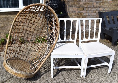 Lot 514 - A vintage rattan swinging egg chair together...