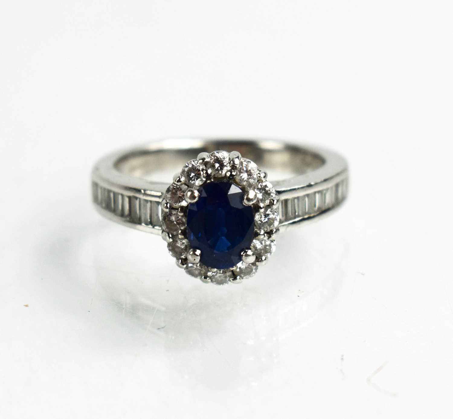 Lot 81 - A platinum, sapphire and diamond ring, the...