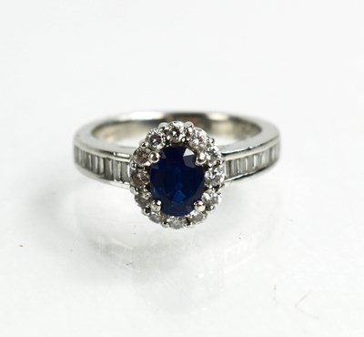 Lot 27 - A platinum, sapphire and diamond ring, the...