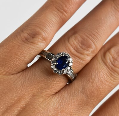 Lot 81 - A platinum, sapphire and diamond ring, the...