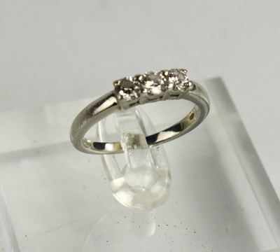 Lot 82 - A platinum and diamond three stone ring, the...