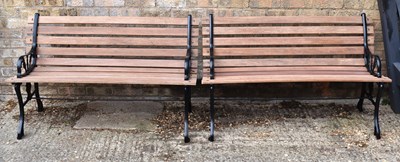 Lot 491 - A pair of cast iron benches, painted black...