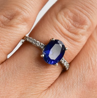 Lot 64 - A 9ct white gold, sapphire and diamond ring,...