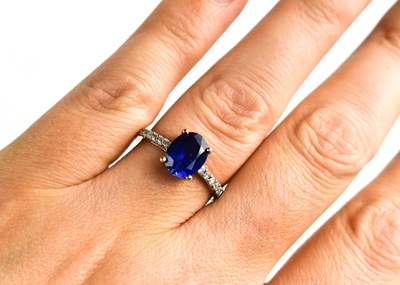 Lot 17 - A 9ct white gold, sapphire and diamond ring,...