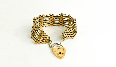 Lot 181 - A 9ct gold gate link charm bracelet with heart...