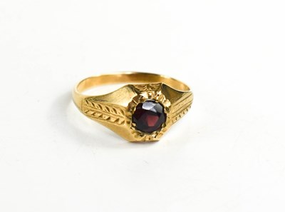 Lot 75 - A 9ct gold and garnet ring, the solitaire...