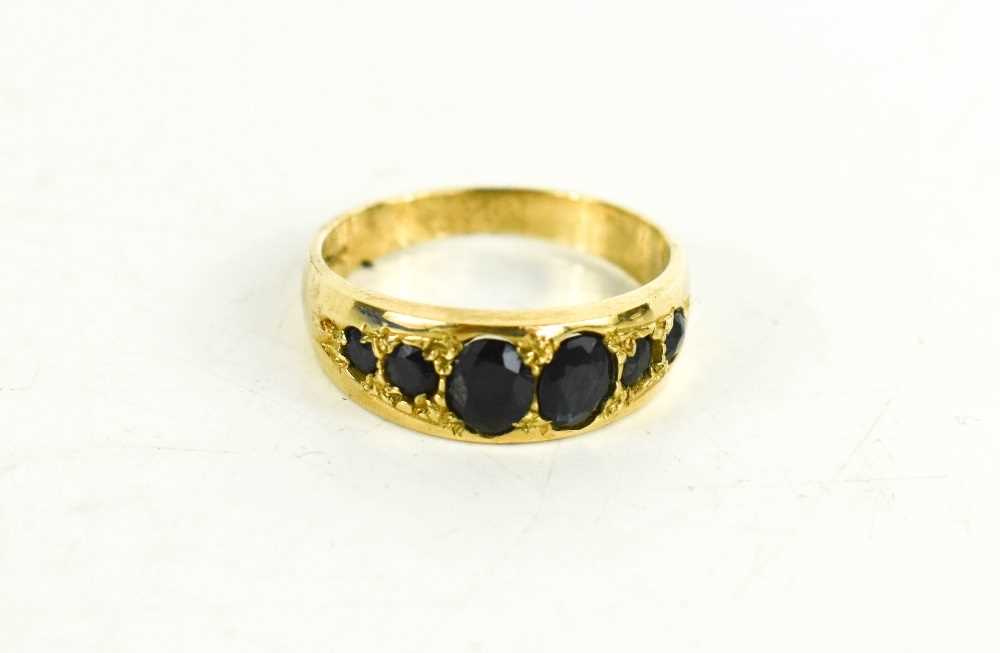 Lot 92 - A 9ct gold and sapphire six stone ring, size O,...