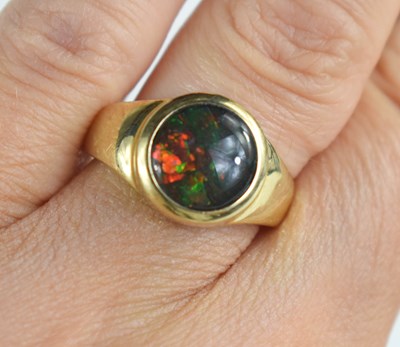 Lot 99 - A 14ct gold and synthetic opal set ring, the...