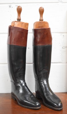 Lot 379 - A pair of black riding boots with brown tops,...