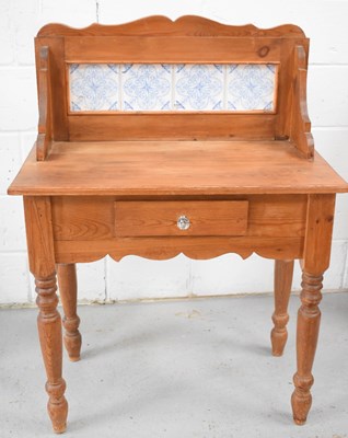 Lot 476 - A pine wash-stand, the tile back set with four...