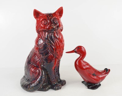 Lot 112 - A Royal Doulton red flambe glazed seated cat,...