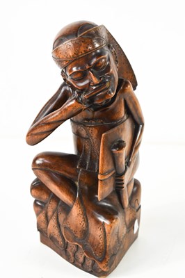 Lot 307 - An Indonesian hardwood carving of a seated man,...