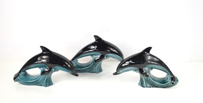 Lot 129 - A group of three Poole Pottery dolphins.