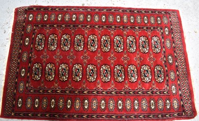 Lot 452 - A Middle Eastern red ground wool rug, with...