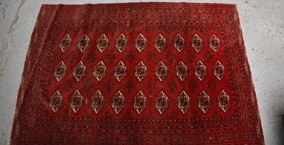 Lot 453 - A Middle Eastern red ground wool rug, with...