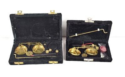 Lot 170 - Two cased sets of vintage brass balance scales...