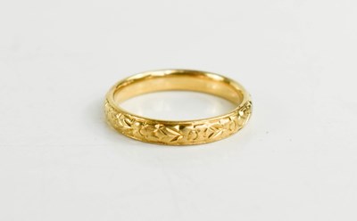 Lot 148 - An 18ct gold wedding band, foliate engraved,...