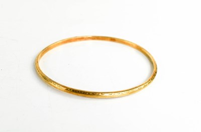 Lot 161 - A 15ct gold arm bangle, with etched decoration,...