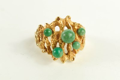 Lot 209 - A late 1960's 9ct gold and jade dress ring in...