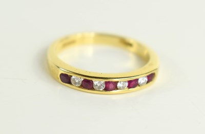 Lot 164 - An 18ct gold, diamond and ruby nine stone,...