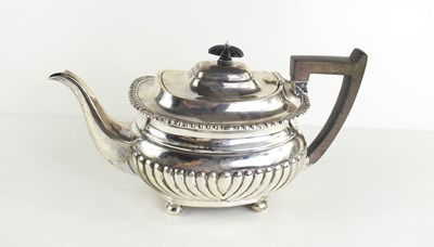 Lot 426 - An Edwardian silver teapot, having half...