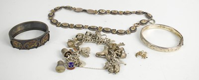 Lot 324 - A silver charm bracelet with twenty seven...