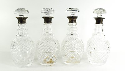 Lot 330 - A set of four cut glass and silver decanters,...