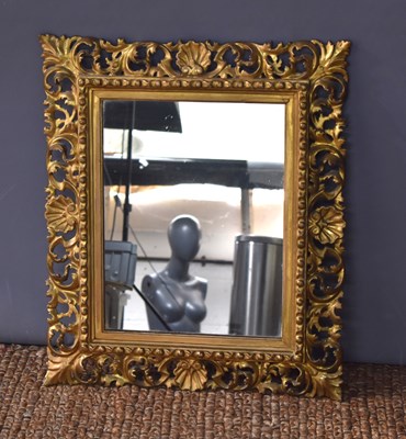 Lot 271 - An antique giltwood wall mirror with shell and...