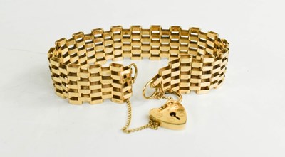 Lot 243 - A 9ct gold panel link bracelet, with a heart...