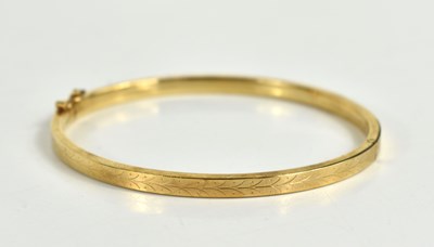 Lot 155 - A 9ct gold bracelet, engraved with foliate...