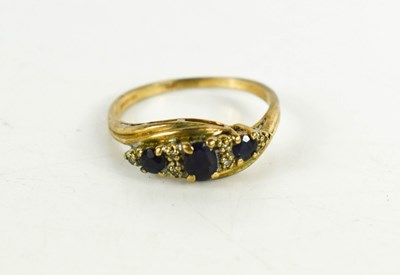 Lot 80 - A 9ct gold diamond and sapphire ring, set with...