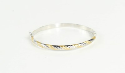 Lot 211 - A 14ct white gold bangle, with matt yellow...