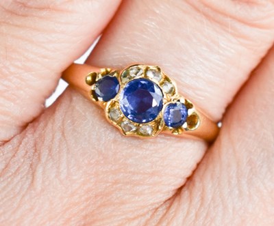 Lot 24 - A gold, pale blue sapphire and diamond ring,...