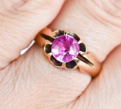 Lot 28 - A 15ct gold and pink sapphire ring, the...