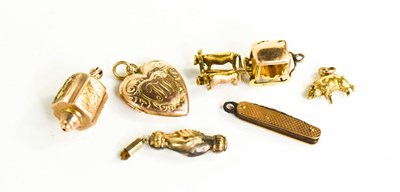 Lot 188 - A group of charms to include a 15ct gold pig,...