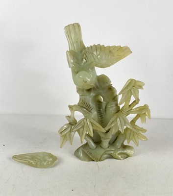 Lot 51 - A Chinese jade carving of a bird perched among...