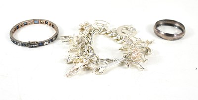 Lot 129 - A silver charm bracelet with twenty one charms...