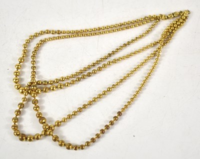 Lot 184 - A gilt metal three strand graduated beaded...