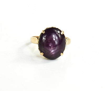 Lot 46 - A 14ct gold and purple star sapphire cabochon...