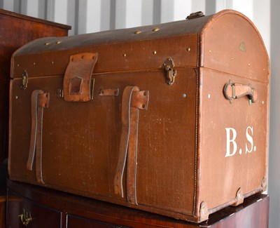 Lot 441 - A vintage domed top travelling trunk, clad in...