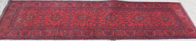 Lot 467 - A Khan Mohamadi red ground wool runner, with...