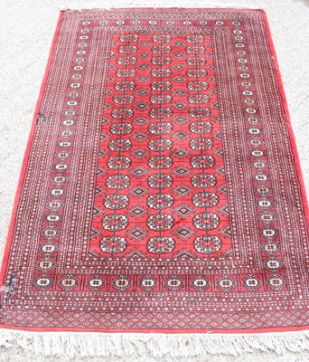 Lot 503 - A Middle Eastern red ground rug, with central...