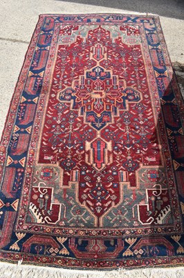 Lot 478 - A Middle Eastern wool rug, red ground with...