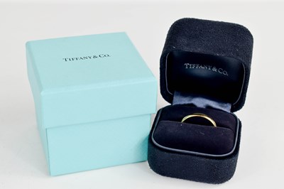 Lot 130 - A Tiffany & Co., 18ct gold wedding band, in...