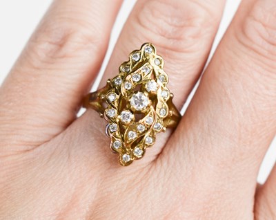 Lot 265 - A 14ct gold and diamond navette form ring, the...